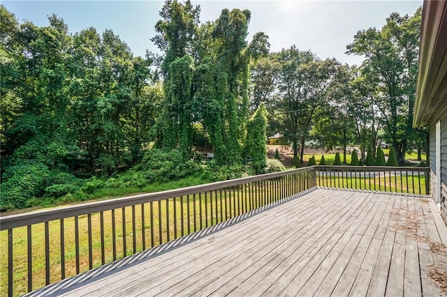 wooden terrace featuring a lawn