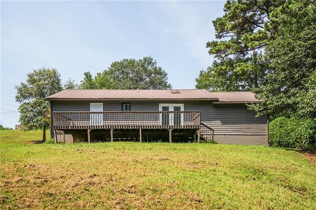 back of property featuring a yard and a deck