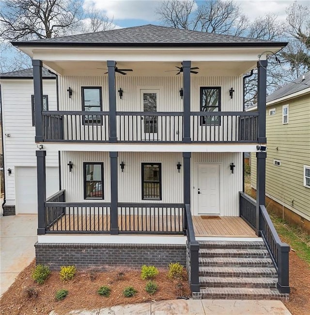 view of front of property featuring ceiling fan, a balcony, covered porch, a shingled roof, and concrete driveway