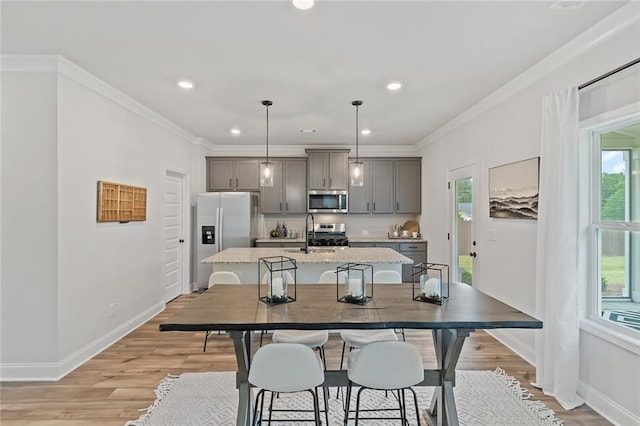 141 Wingate Dr, Auburn, GA 30680 - kitchen featuring appliances with stainless steel finishes, gray cabinets, a center island with sink, plenty of natural light, and recessed lighting