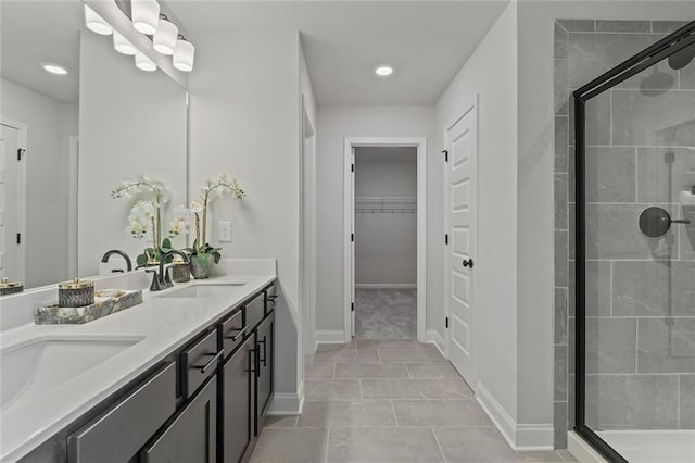 141 Wingate Dr, Auburn, GA 30680 - bathroom featuring a stall shower, double vanity, a spacious closet, tile patterned flooring, and recessed lighting