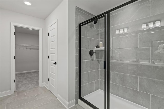 141 Wingate Dr, Auburn, GA 30680 - full bathroom featuring a shower stall, a walk in closet, recessed lighting, and tile patterned flooring