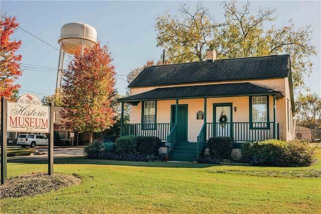 141 Wingate Dr, Auburn, GA 30680 - view of front facade with covered porch, roof with shingles, a front yard, and a chimney