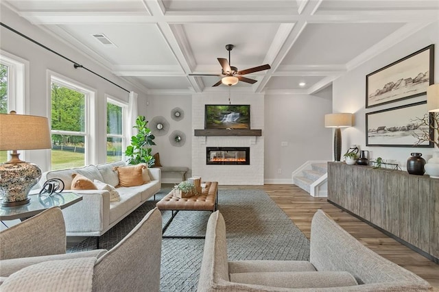 141 Wingate Dr, Auburn, GA 30680 - living area with wood finished floors, a large fireplace, a ceiling fan, coffered ceiling, and beamed ceiling