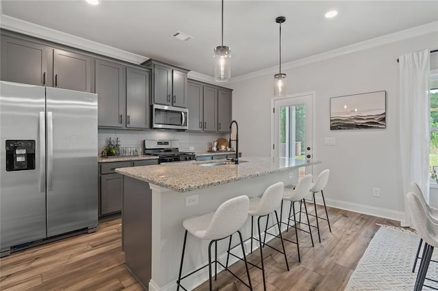 141 Wingate Dr, Auburn, GA 30680 - kitchen featuring appliances with stainless steel finishes, tasteful backsplash, gray cabinets, plenty of natural light, and ornamental molding