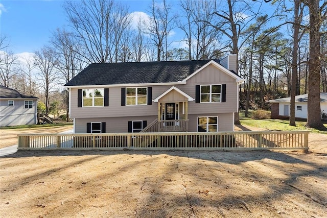 raised ranch featuring a chimney