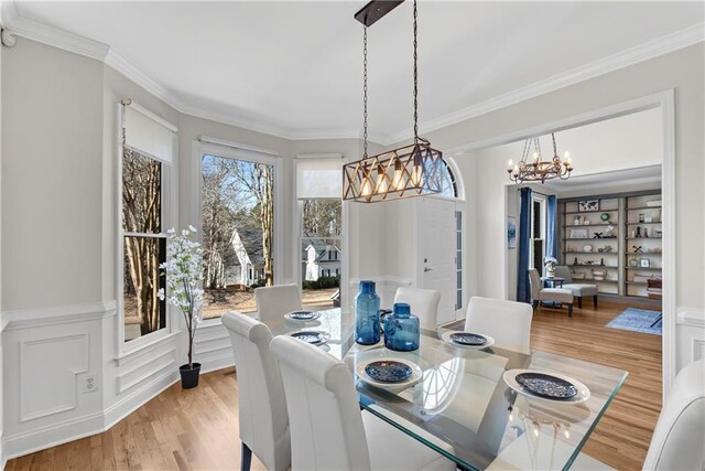 dining room featuring ornamental molding and light hardwood / wood-style floors