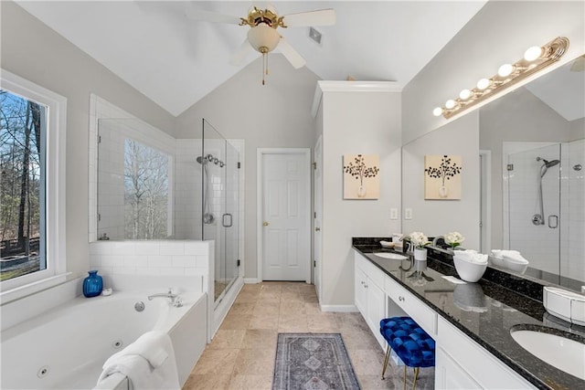 bathroom featuring vanity, independent shower and bath, and vaulted ceiling