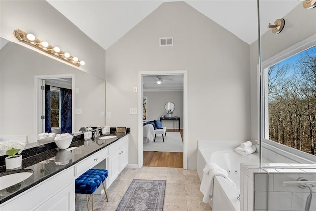 bathroom featuring vanity, a tub, tile patterned floors, and high vaulted ceiling