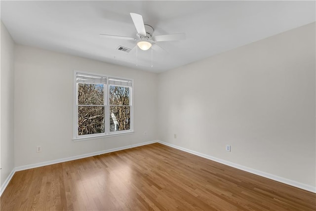 spare room with hardwood / wood-style floors and ceiling fan