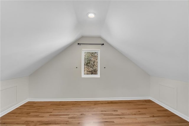 bonus room featuring vaulted ceiling and light wood-type flooring