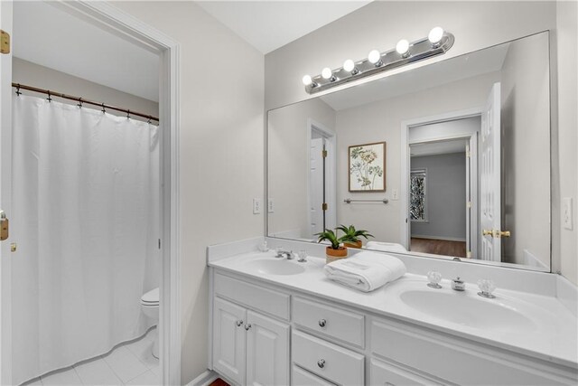 bathroom featuring vanity and toilet