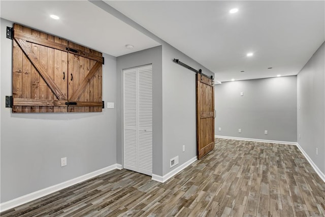 interior space featuring hardwood / wood-style flooring and a barn door