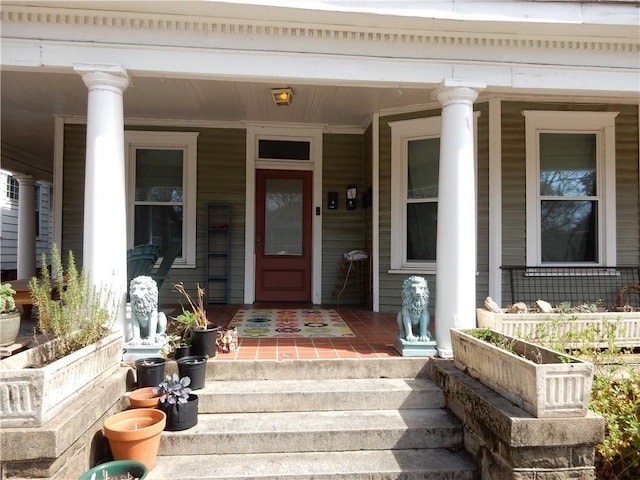 view of exterior entry featuring covered porch