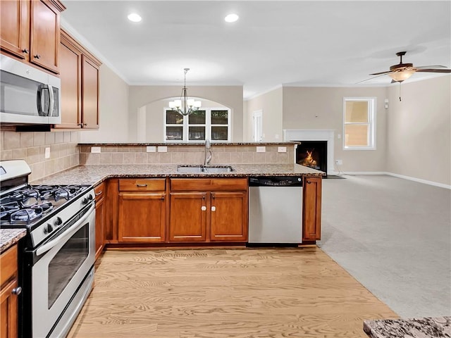 4206 Weavers White Ln Unit 17, Austell, GA 30106 - kitchen with stainless steel appliances, sink, backsplash, light hardwood / wood-style floors, and ceiling fan with notable chandelier