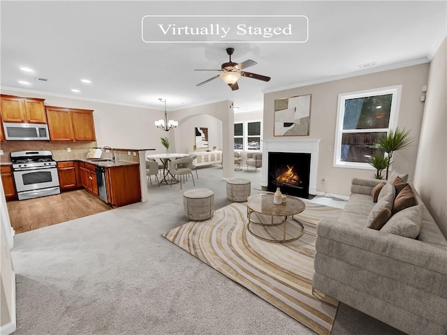 4206 Weavers White Ln Unit 17, Austell, GA 30106 - living room featuring ceiling fan with notable chandelier, light carpet, sink, and ornamental molding