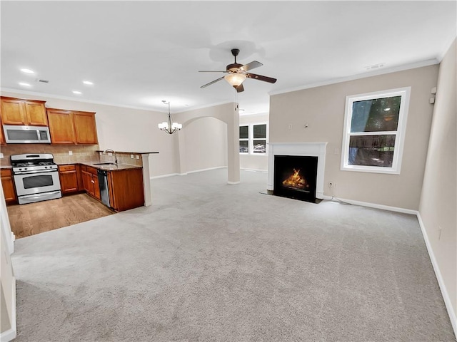 4206 Weavers White Ln Unit 17, Austell, GA 30106 - unfurnished living room with ornamental molding, light carpet, ceiling fan with notable chandelier, and sink