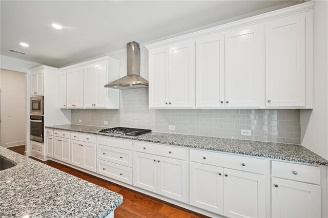 8125 Beryl Overlook, Gainesville, GA 30506 - kitchen featuring wall chimney exhaust hood, appliances with stainless steel finishes, white cabinets, tasteful backsplash, and recessed lighting