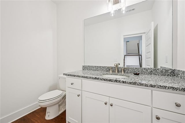 8125 Beryl Overlook, Gainesville, GA 30506 - bathroom featuring toilet, vanity, baseboards, and wood finished floors