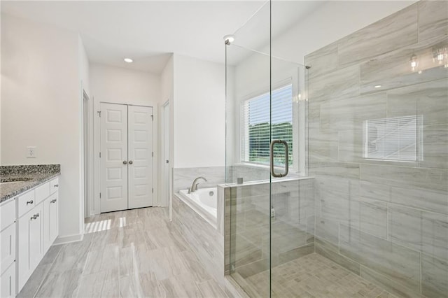 8125 Beryl Overlook, Gainesville, GA 30506 - bathroom with vanity, a garden tub, a closet, and a stall shower