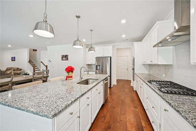 8125 Beryl Overlook, Gainesville, GA 30506 - kitchen featuring wall chimney range hood, appliances with stainless steel finishes, a sink, white cabinets, and decorative backsplash