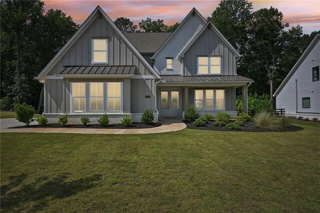 8125 Beryl Overlook, Gainesville, GA 30506 - modern farmhouse style home with a standing seam roof, board and batten siding, french doors, and a front yard