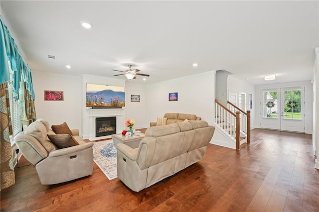 8125 Beryl Overlook, Gainesville, GA 30506 - living room featuring recessed lighting, ceiling fan, dark wood-style floors, a glass covered fireplace, and stairs
