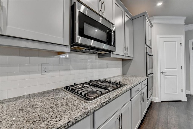 4232 Perimeter Park E Unit 110, Atlanta, GA 30341 - kitchen featuring stainless steel appliances, ornamental molding, dark wood-style flooring, decorative backsplash, and light stone countertops