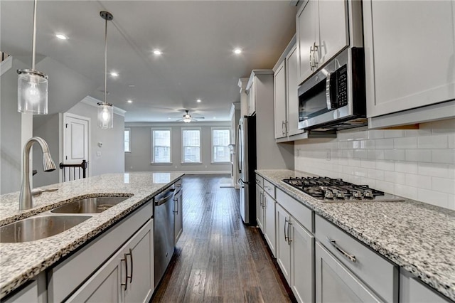4232 Perimeter Park E Unit 110, Atlanta, GA 30341 - kitchen with appliances with stainless steel finishes, tasteful backsplash, pendant lighting, ceiling fan, and dark wood-type flooring