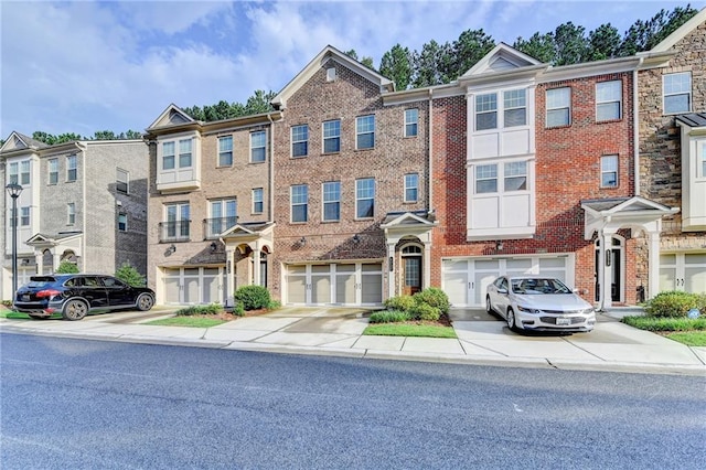 4232 Perimeter Park E Unit 110, Atlanta, GA 30341 - view of front of house with brick siding, driveway, and an attached garage