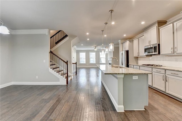 4232 Perimeter Park E Unit 110, Atlanta, GA 30341 - kitchen featuring stainless steel appliances, open floor plan, a ceiling fan, a center island with sink, and dark wood-style flooring
