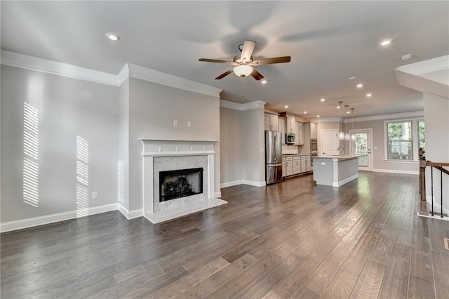 4232 Perimeter Park E Unit 110, Atlanta, GA 30341 - unfurnished living room featuring ceiling fan, a high end fireplace, dark wood-style flooring, ornamental molding, and recessed lighting