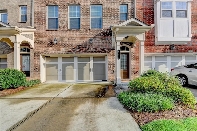 4232 Perimeter Park E Unit 110, Atlanta, GA 30341 - view of front facade with driveway, an attached garage, and brick siding