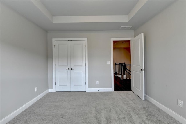 4232 Perimeter Park E Unit 110, Atlanta, GA 30341 - unfurnished bedroom featuring carpet flooring, a closet, and a raised ceiling