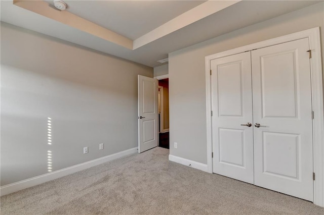 4232 Perimeter Park E Unit 110, Atlanta, GA 30341 - unfurnished bedroom featuring carpet floors, a closet, and a tray ceiling