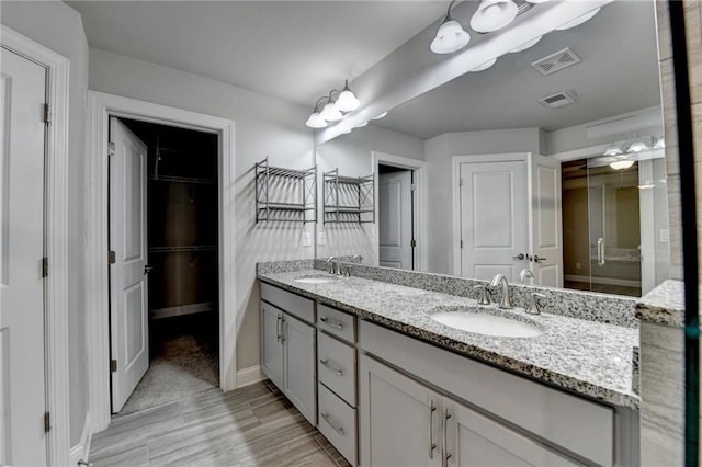 4232 Perimeter Park E Unit 110, Atlanta, GA 30341 - full bath featuring double vanity, wood finished floors, and a walk in closet