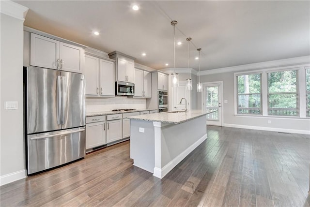 4232 Perimeter Park E Unit 110, Atlanta, GA 30341 - kitchen with stainless steel appliances, a center island with sink, dark wood-style flooring, light stone counters, and recessed lighting