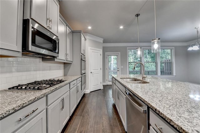4232 Perimeter Park E Unit 110, Atlanta, GA 30341 - kitchen with appliances with stainless steel finishes, ornamental molding, dark wood-style flooring, light stone counters, and backsplash