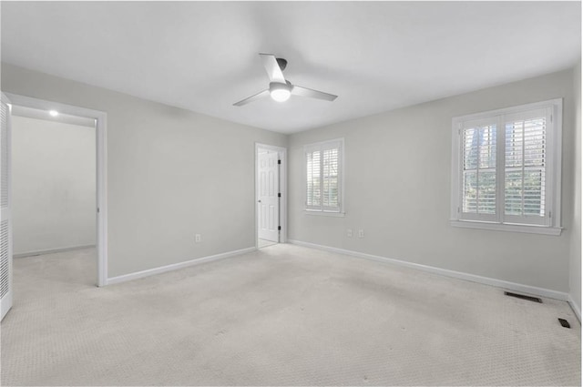 unfurnished room featuring ceiling fan and light carpet