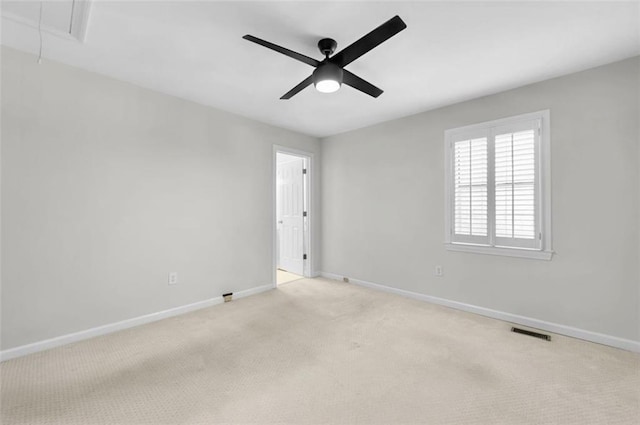 spare room featuring ceiling fan and light colored carpet