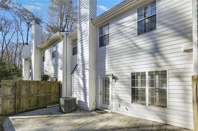 rear view of property featuring a patio and central AC unit