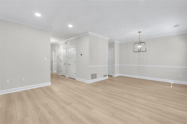 unfurnished dining area featuring light wood-type flooring, an inviting chandelier, and crown molding