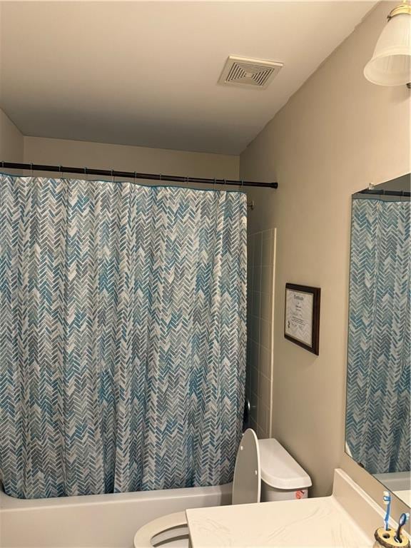 full bathroom with toilet, shower / bath combo, vanity, and visible vents