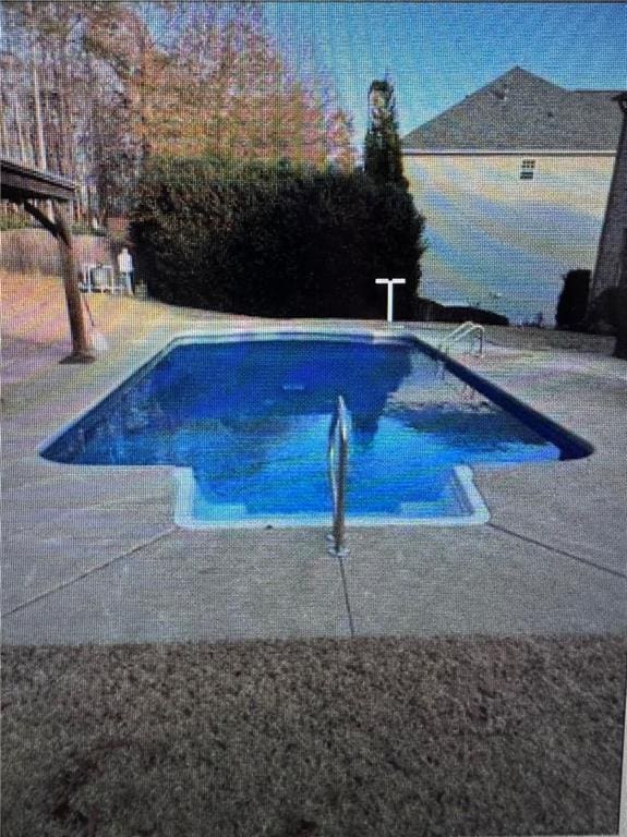 view of swimming pool with a fenced in pool