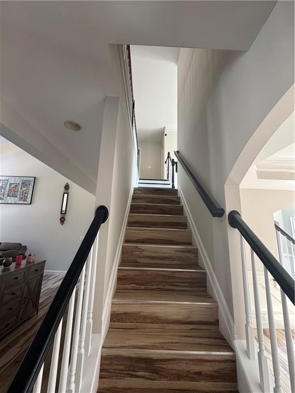 stairs with baseboards and wood finished floors