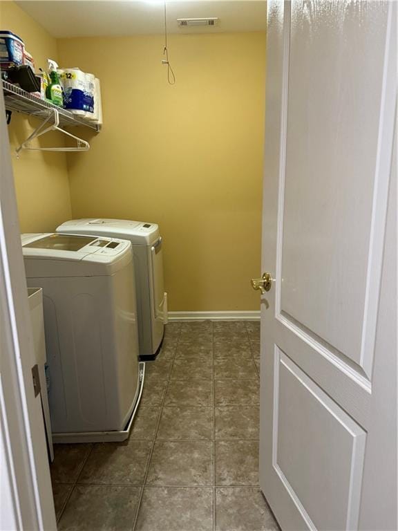 washroom featuring visible vents, baseboards, laundry area, tile patterned floors, and washer and dryer