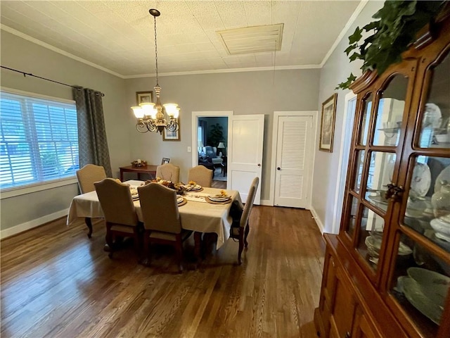 dining space with ornamental molding, a chandelier, and dark hardwood / wood-style floors