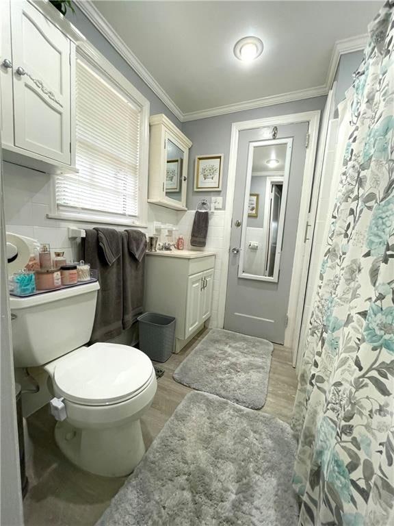 bathroom featuring hardwood / wood-style floors, vanity, toilet, and ornamental molding