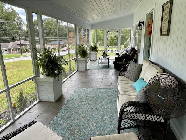 sunroom featuring lofted ceiling and wooden ceiling