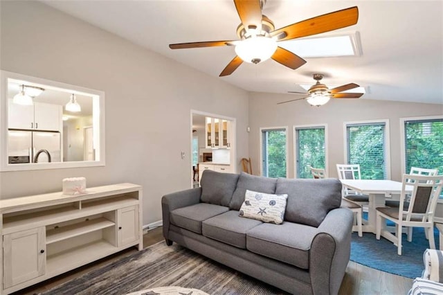 living area with lofted ceiling, ceiling fan, and wood finished floors